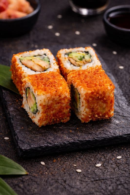 California Uramaki 4 pcs — 4 popular roll with shrimps, avocado, cucumber and covered in red tobiko- a harmony of flavor and te
