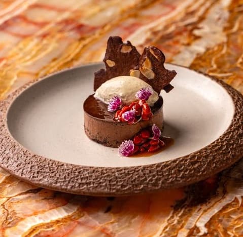 Chocolate mousse with goji jam — Rich chocolate mousse cake served with mascarpone-banana cream and homemade goji jam. Deep chocolate