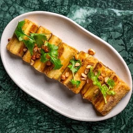 Crunchy eggplant — Crispy eggplant glazed with orange sauce and topped with peanuts and cilantro. Sweet, crunchy, and f