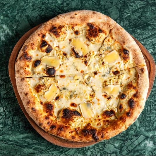 Five cheese and honey — Neapolitan-style pizza with mozzarella, parmesan, gorgonzola, smoked ricotta, and brie. Finished wit