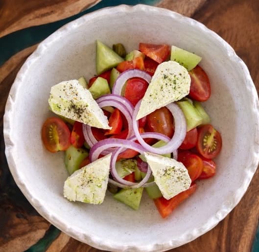 Greek — A refreshing Greek salad with cucumber, tomato, bell pepper, red onion, feta cheese, olives, and cap