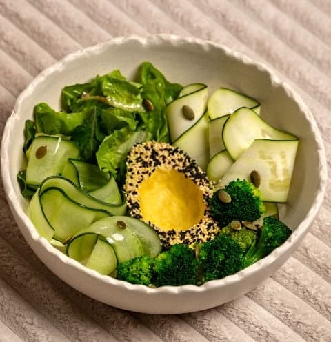Green bowl — A refreshing green salad with broccoli, zucchini, cucumber, mixed greens, and sesame-crusted avocado