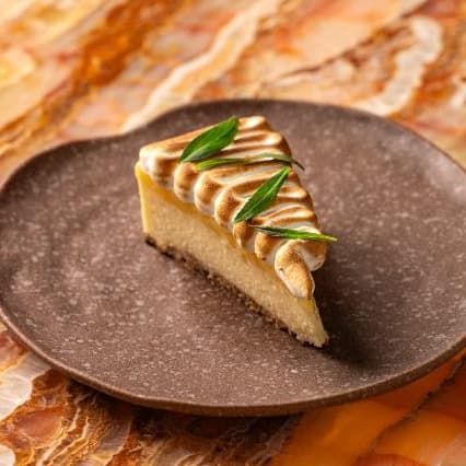 Lemon tart — Light lemon mousse tart finished with burnt meringue. Fresh, citrusy, and delicately sweet.