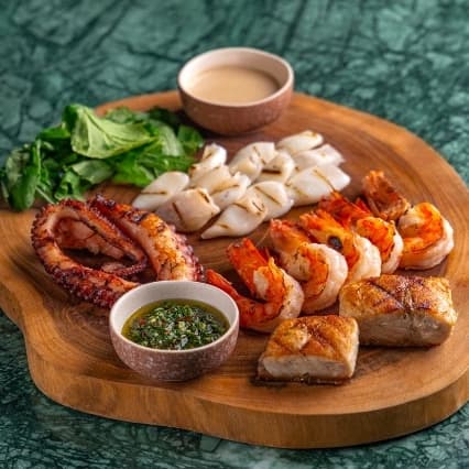 Ocean set to share — A seafood platter with shrimp, squid, barramundi, and octopus served with white wine sauce and chimi