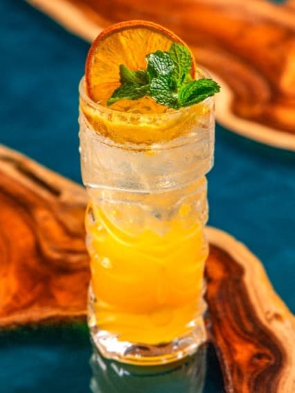 Orange Squash — Refreshing sparkling orange drink with bright citrus flavor. Light, bubbly, and perfect for cooling
