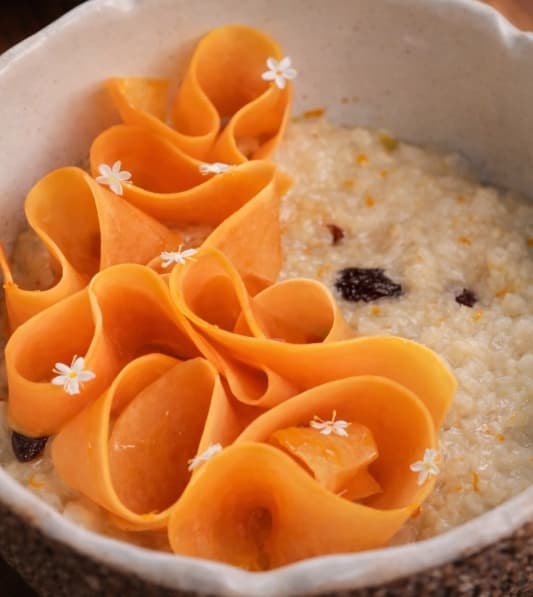 Rice porridge with raisin and orange zest — Smooth rice porridge cooked in coconut milk with fragrant orange zest and sweet rum-marinated raisin