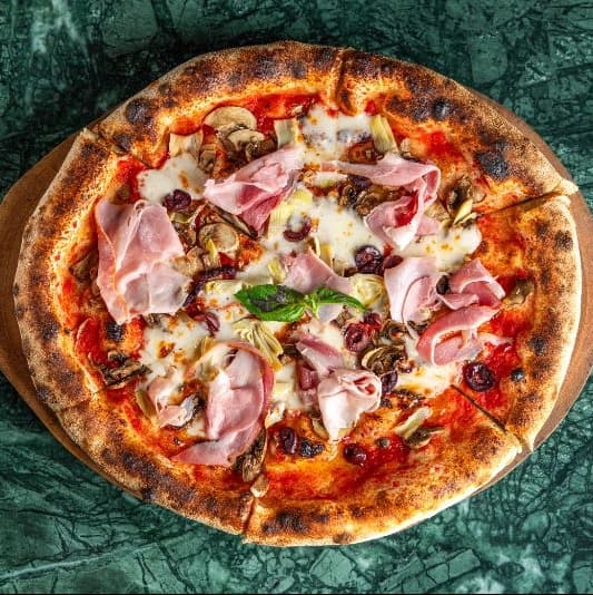 Smoked cotto and mushrooms — Neapolitan pizza with tomato sauce, mozzarella, smoked ham, and mushrooms. Rich, savory, and full of