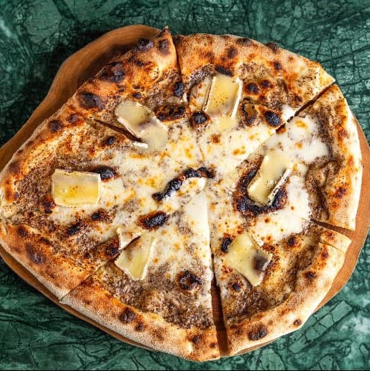 Truffle and brie — Creamy Neapolitan-style pizza with aromatic truffle sauce, melted mozzarella, and delicate brie chee