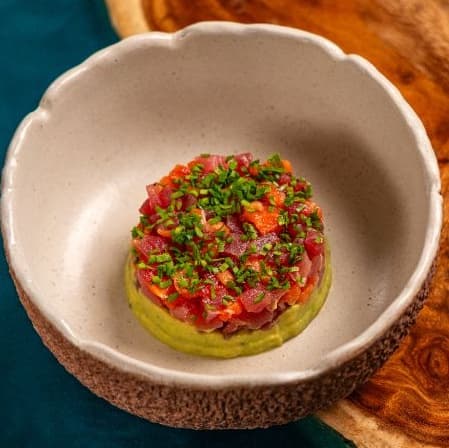 Tuna and salmon tar-tar on guacamole — Fresh tuna and salmon served over creamy guacamole with delicate seasoning and olive oil. Bright, re